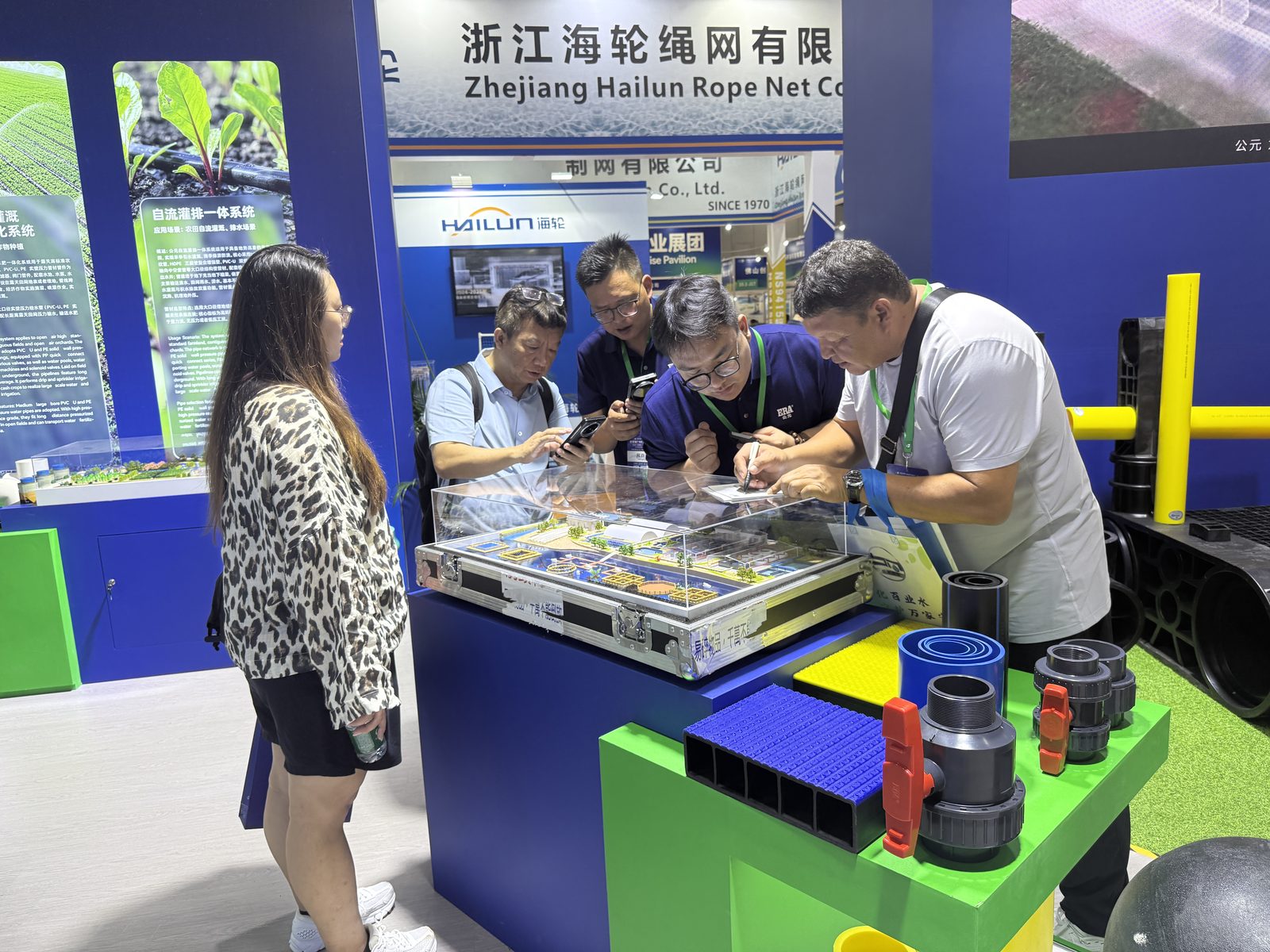 ERA staff discussing an HDPE deep water aquaculture cage layout with visitors at Guangzhou Fisheries Expo 2026